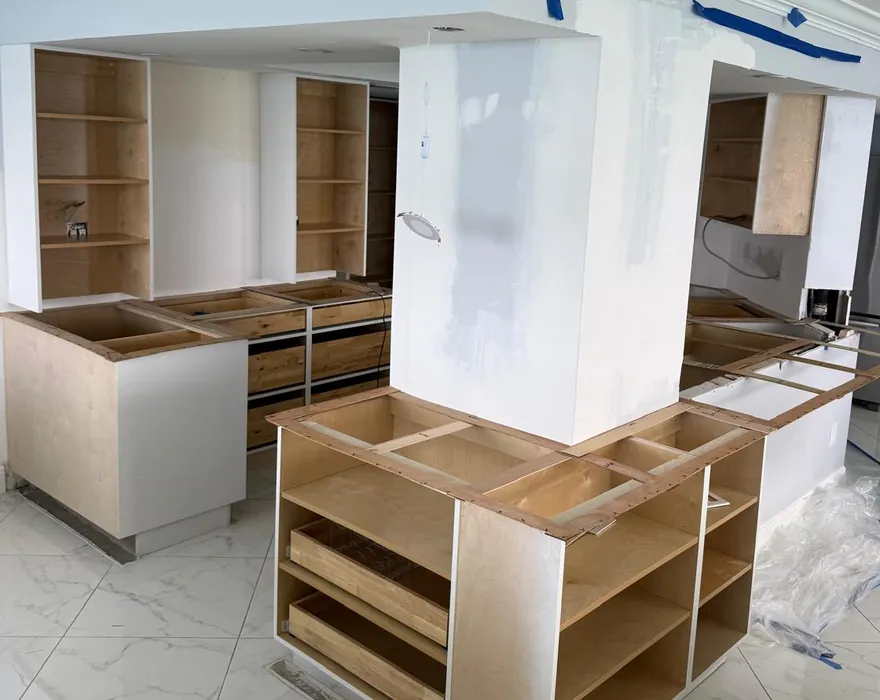 Wood templates laid across new island and perimeter cabinets before the countertops go in