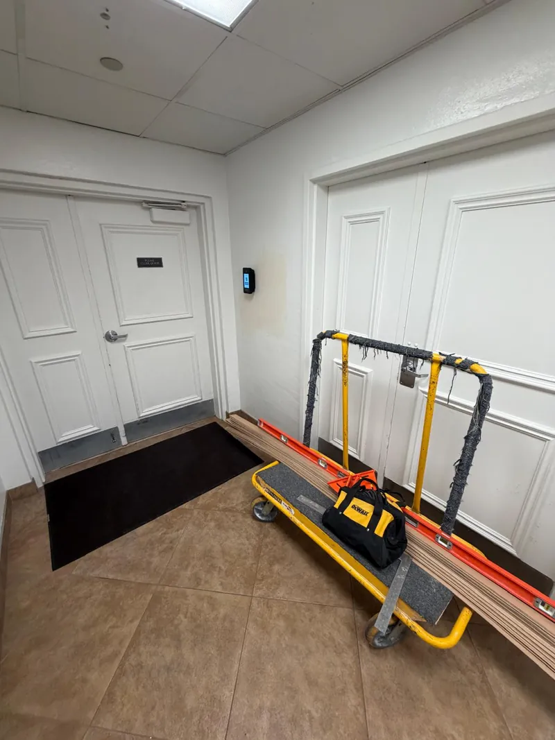Padded A-frame stone cart staged in a building hallway