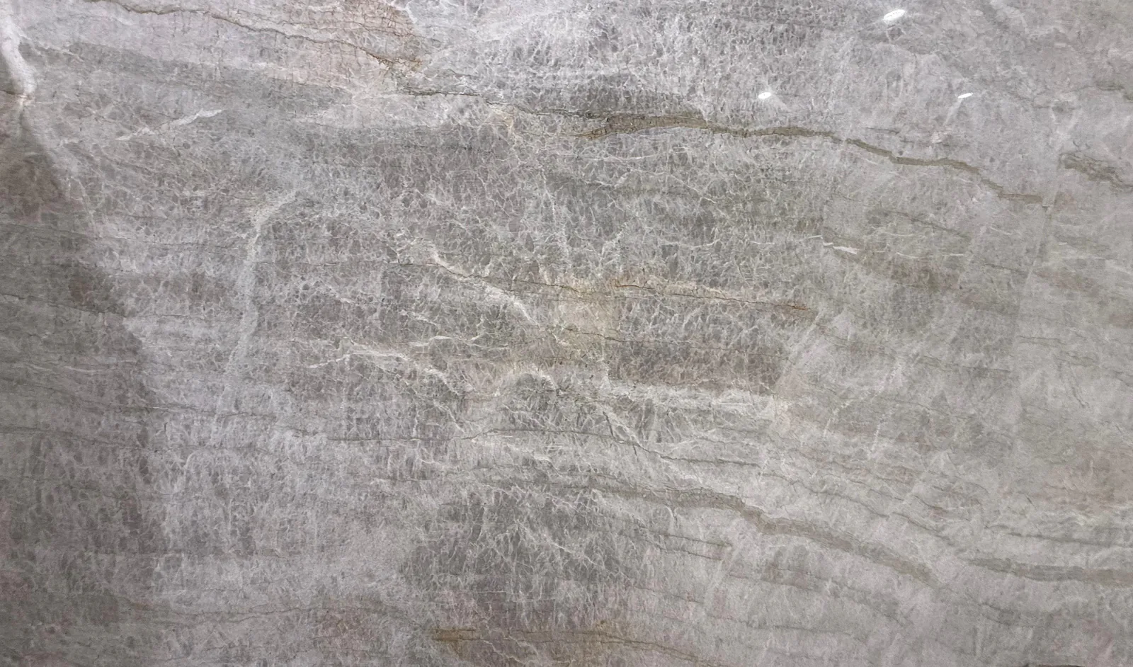Taj Mahal quartzite, slab AC-12: a full slab in taupe gray with wavy white bands