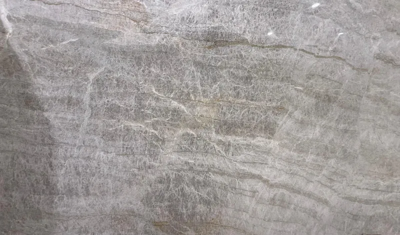 Taj Mahal quartzite, slab AC-12: a full slab in taupe gray with wavy white bands