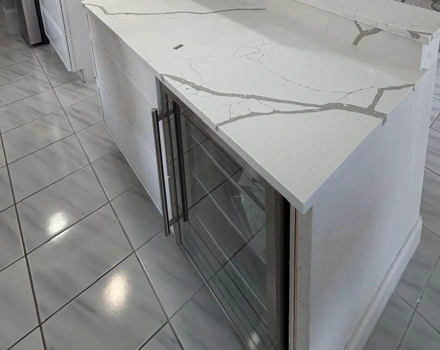 White veined bar counter with a waterfall end and a built-in wine cooler