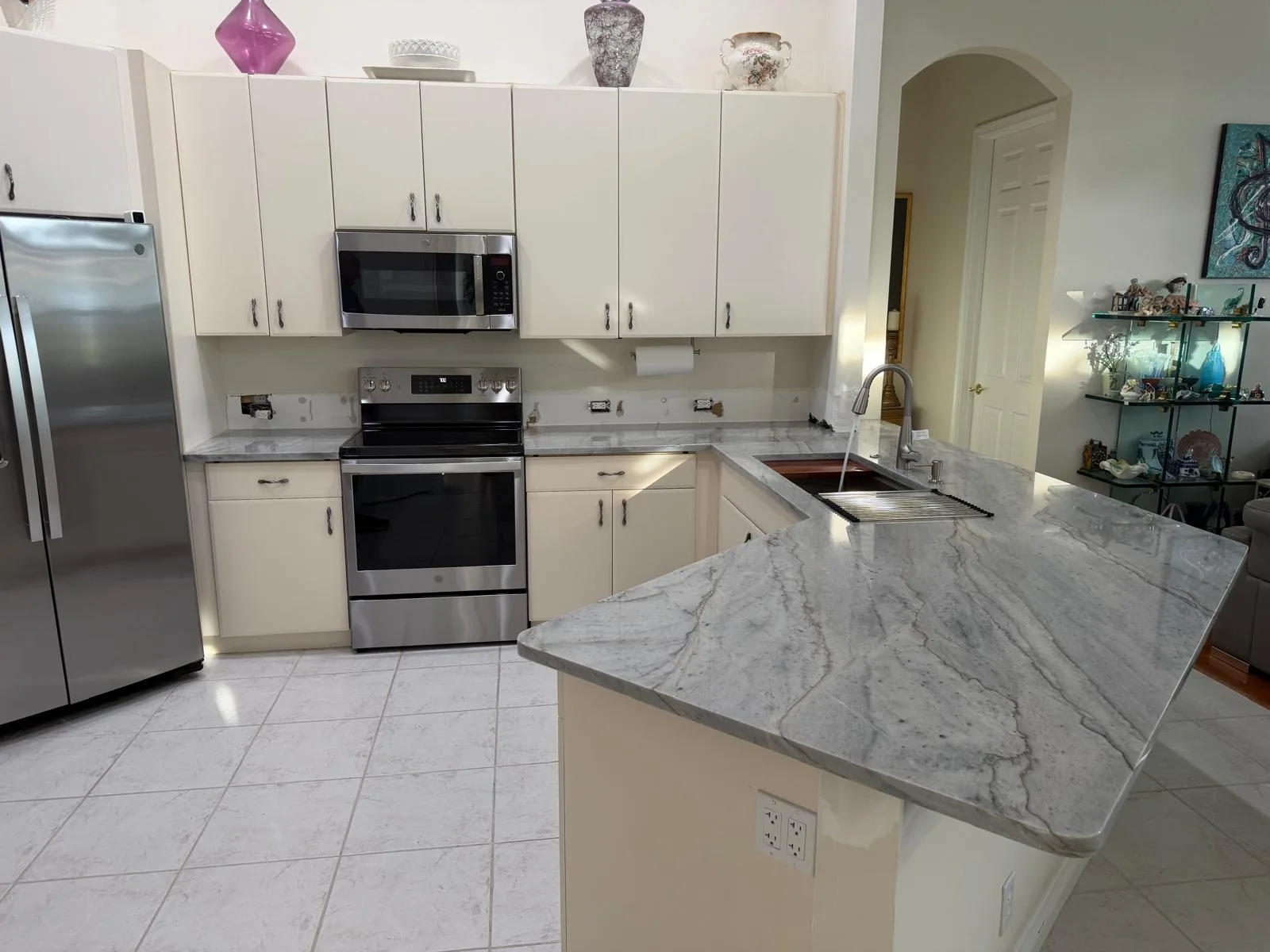 Kitchen after: new gray granite countertops and peninsula