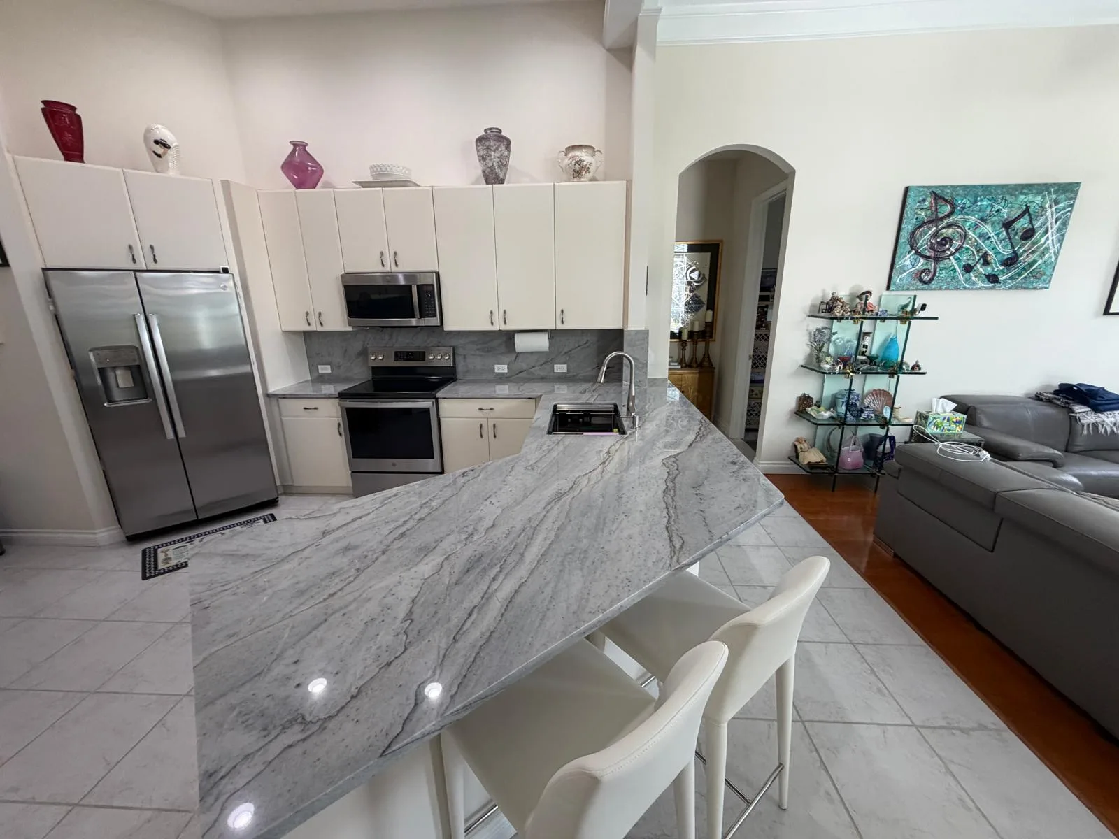 Gray granite kitchen peninsula with bar seating