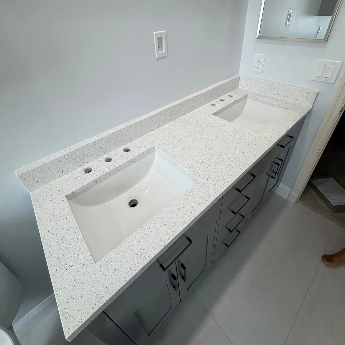 White quartz vanity top with integrated sink, a typical remnant-size project