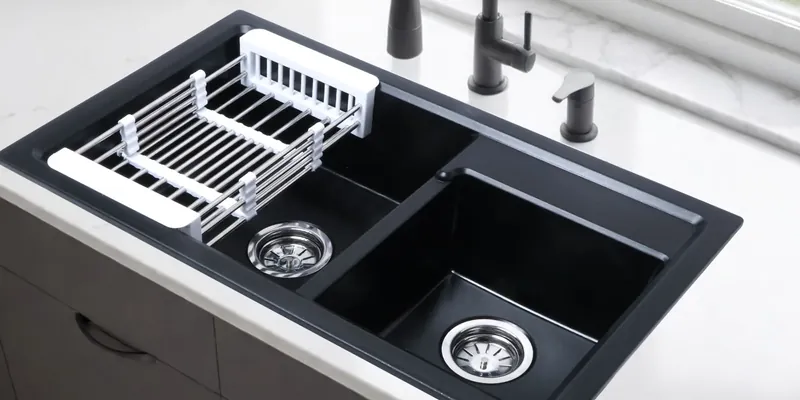 Black double-bowl sink with a drying rack across one bowl, manufacturer photo